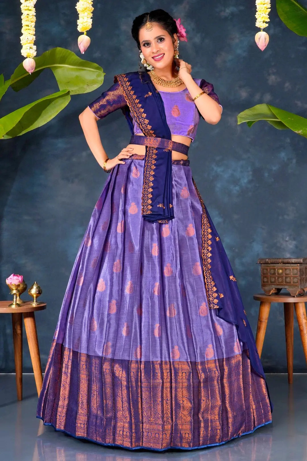 Woman in a traditional purple and blue lehenga choli with dupatta