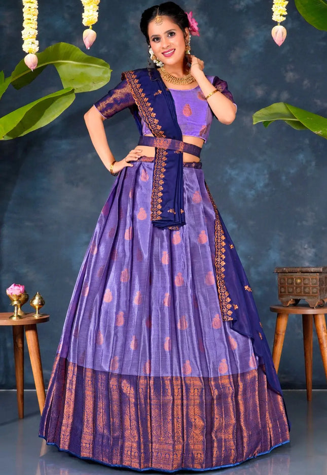Woman in a traditional purple and blue lehenga choli with dupatta
