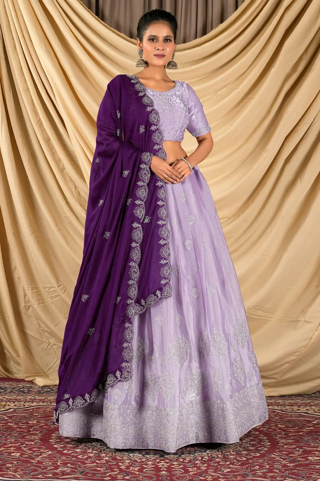 Woman wearing a purple lehenga choli with dupatta