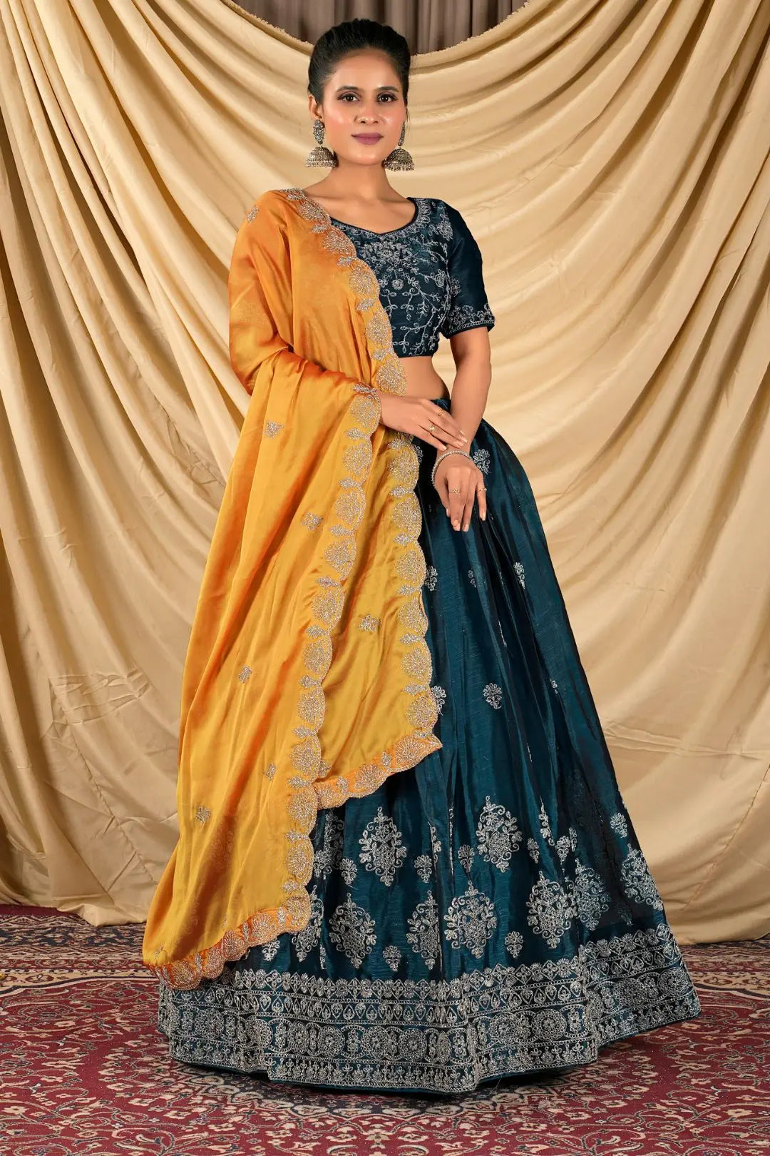 Woman wearing a blue and yellow lehenga choli with dupatta