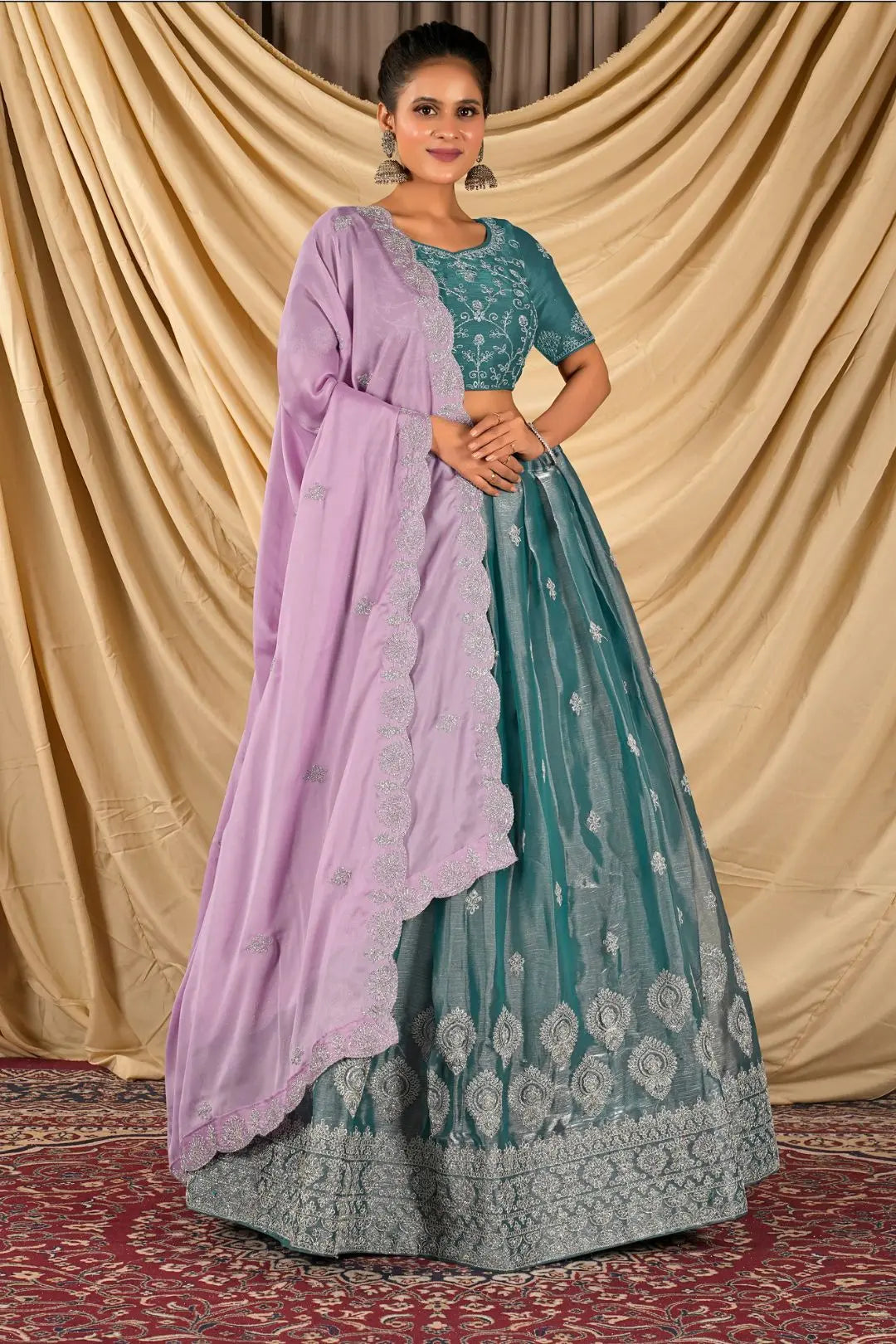 Woman wearing a teal and purple traditional lehenga choli with dupatta