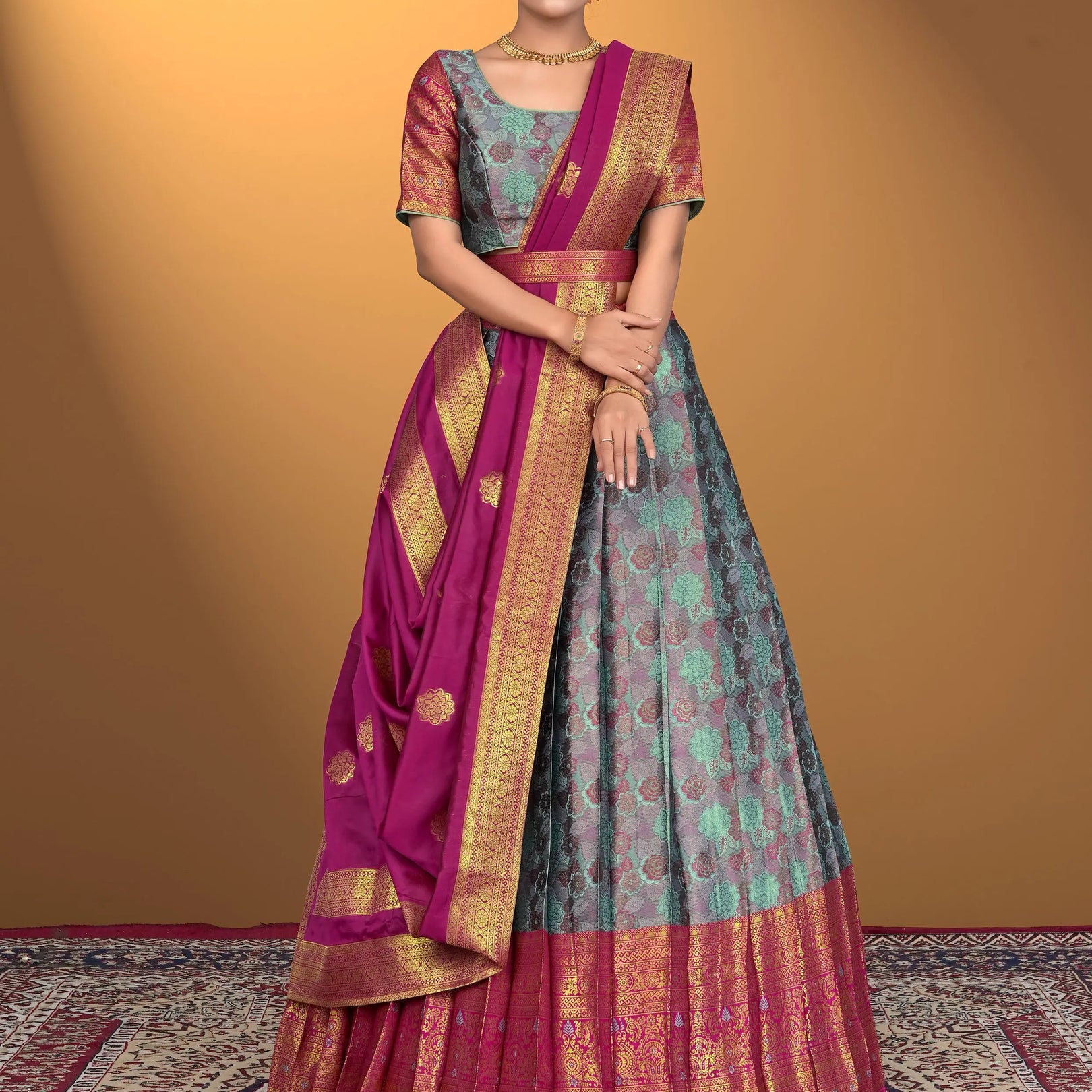 Woman wearing a traditional lehenga choli with a pink border