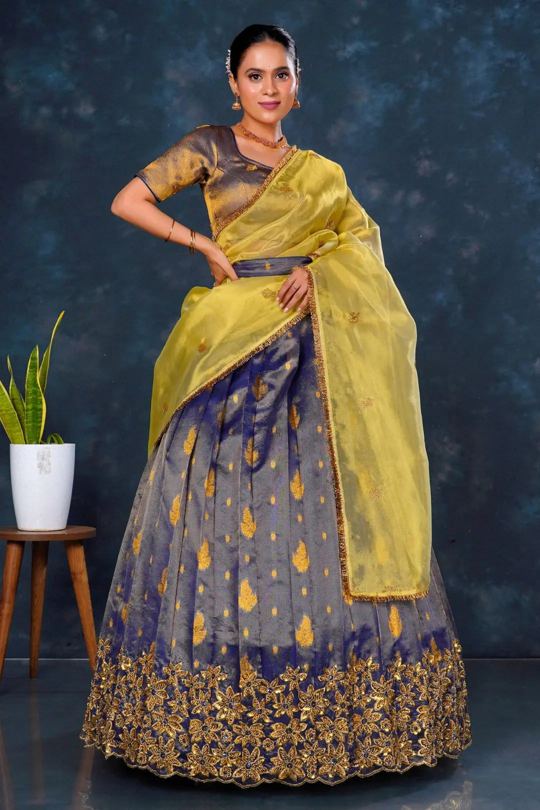 Woman in a traditional outfit with a yellow dupatta