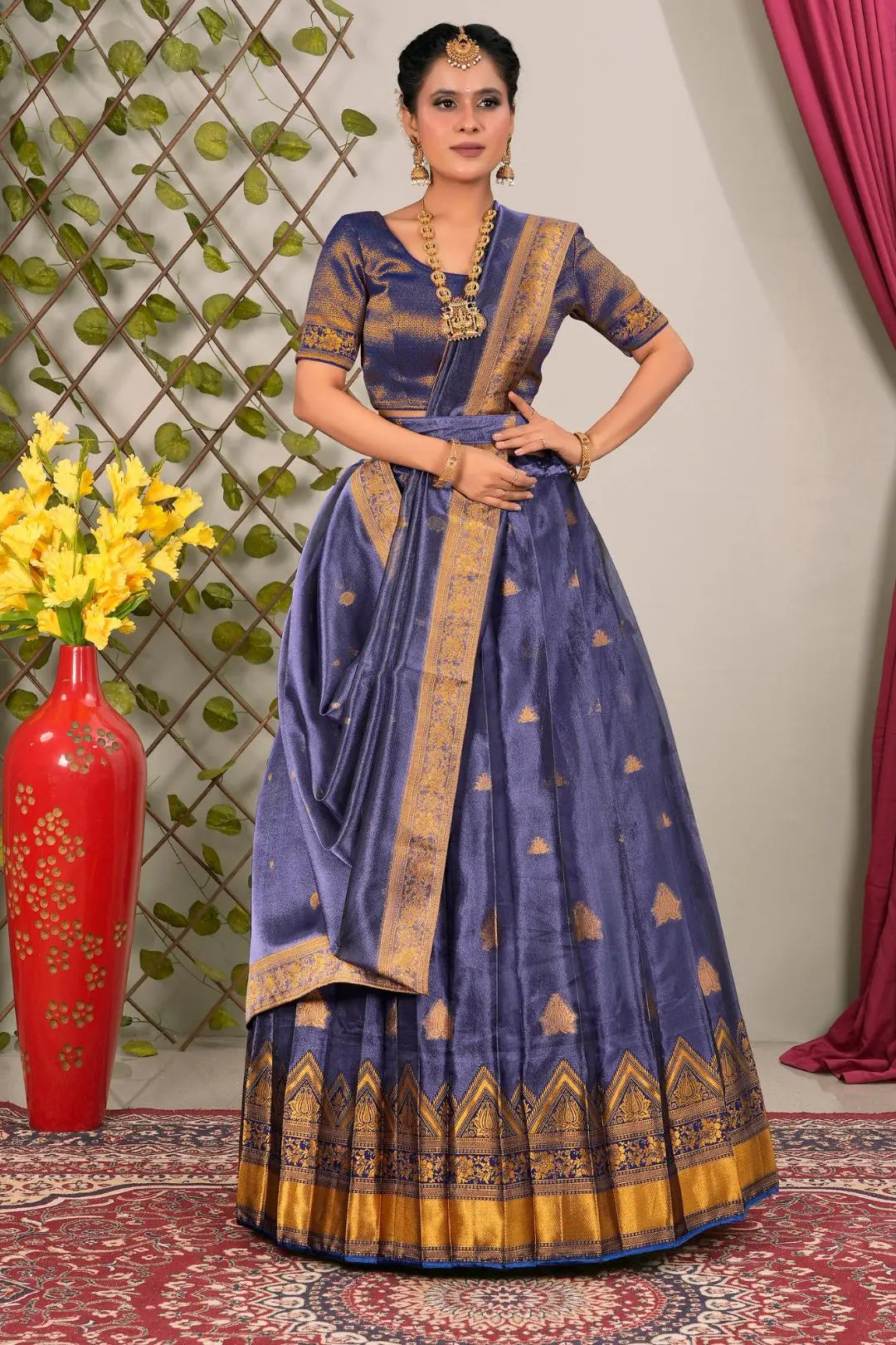 Woman wearing a traditional blue lehenga choli with dupatta
