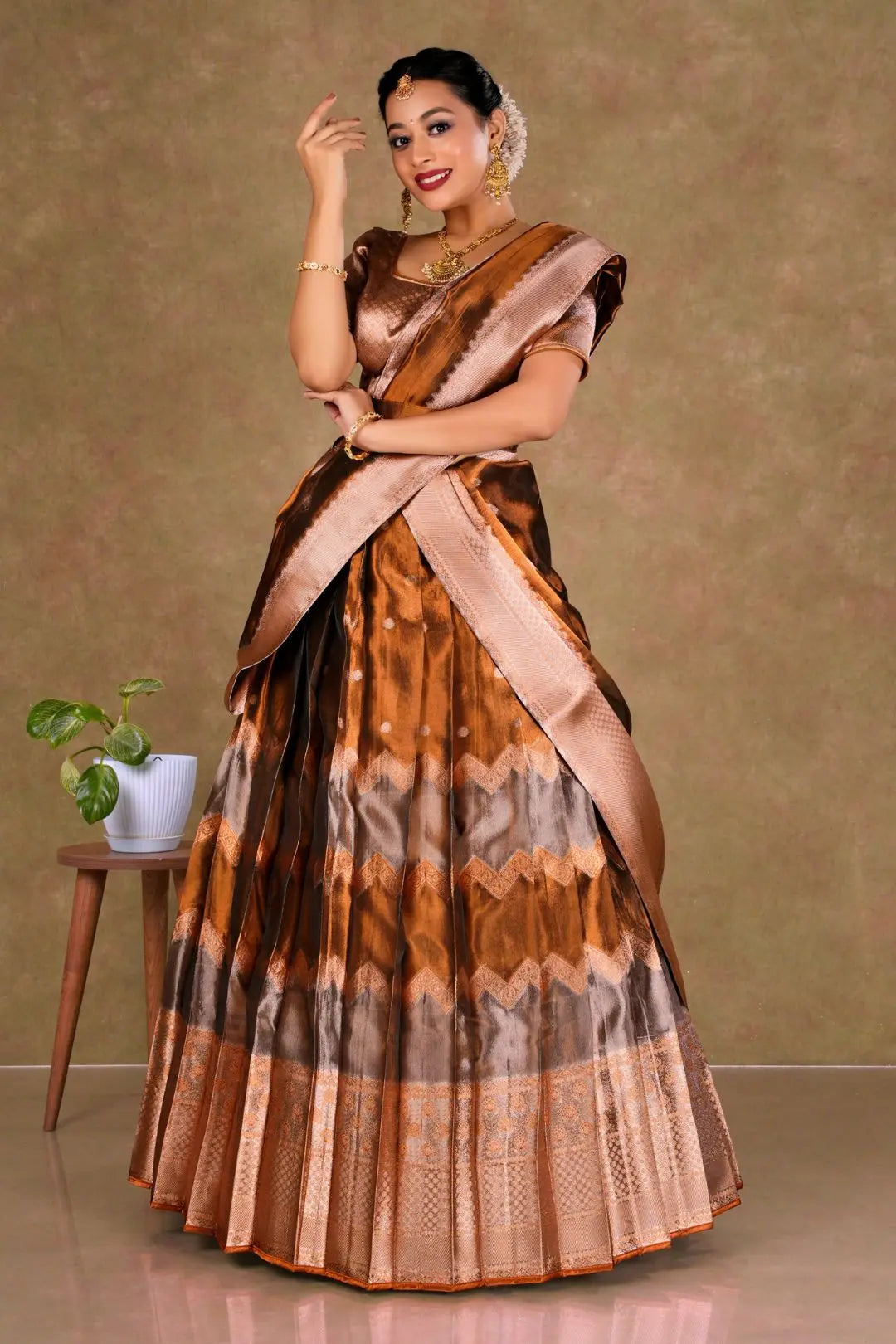 Woman wearing a traditional lehenga with a brown and beige pattern