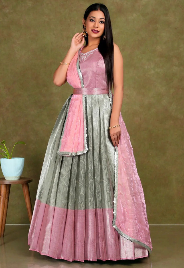 Woman wearing a pink and gray traditional lehenga choli with dupatta