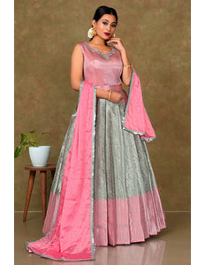 Woman wearing a pink and gray traditional outfit with a matching dupatta