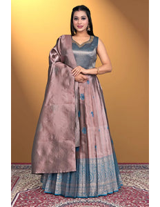 Woman wearing a traditional outfit with a brown dupatta