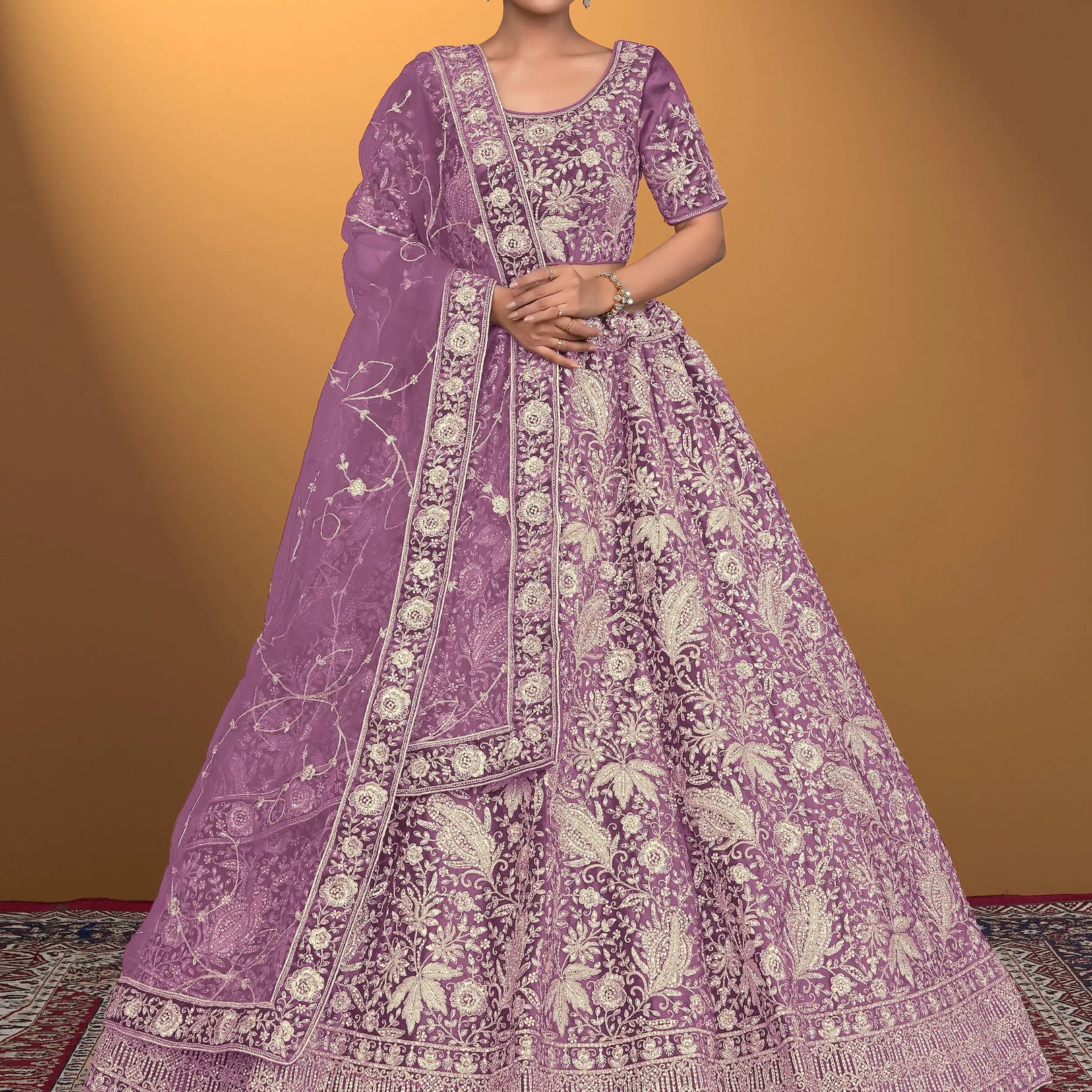 Woman wearing a purple embroidered traditional outfit on a patterned