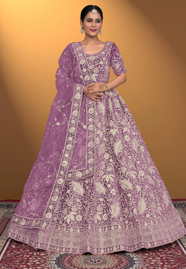 Woman wearing a purple embroidered traditional outfit on a patterned
