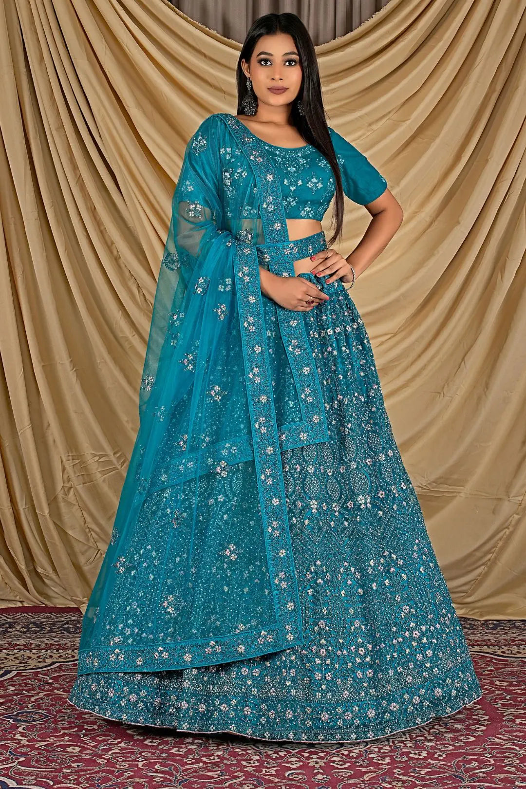 Woman wearing a blue embroidered traditional lehenga choli with dupatta