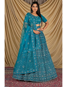 Woman wearing a blue embroidered traditional lehenga choli with dupatta