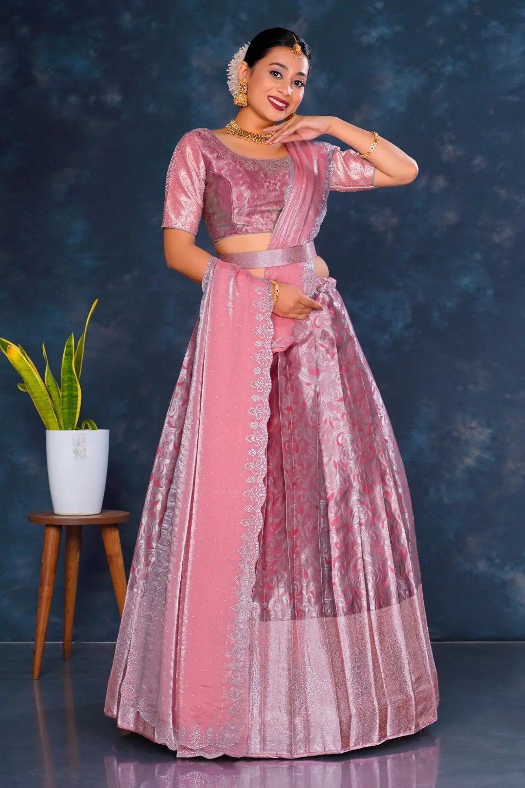 Woman in a pink traditional lehenga choli with dupatta