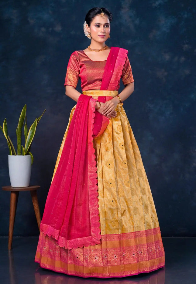 Woman wearing a traditional outfit with a pink and gold lehenga choli with dupatta