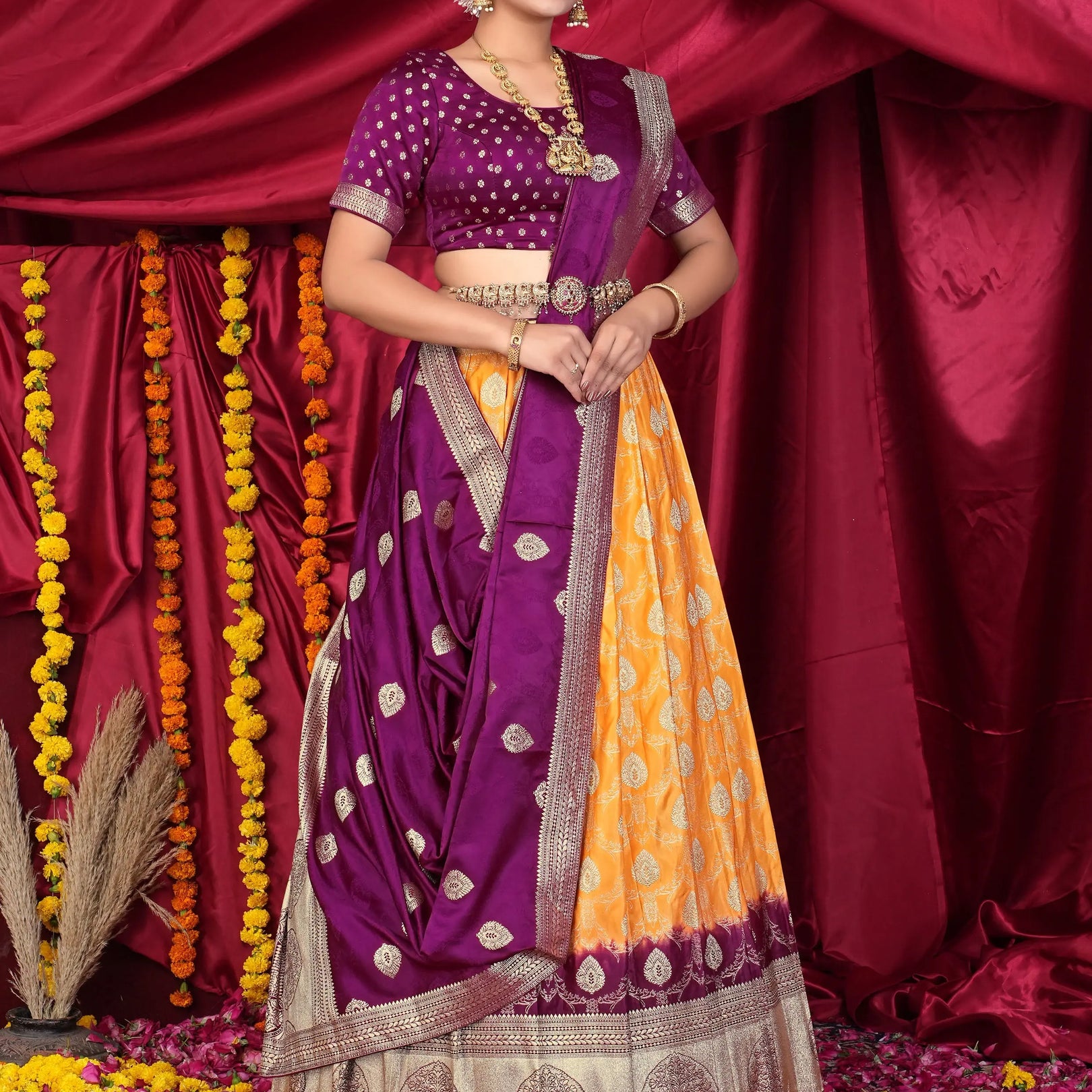 Woman in a traditional purple and orange lehenga choli