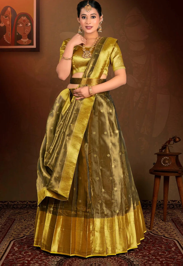 Woman in a traditional gold lehenga choli with dupatta