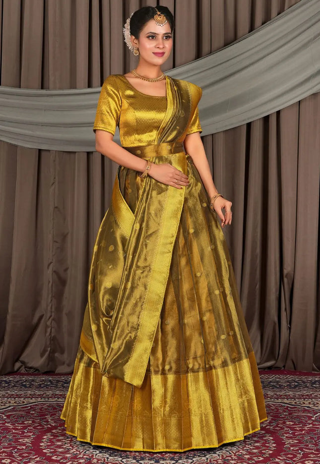 Woman wearing a gold lehenga with a matching blouse