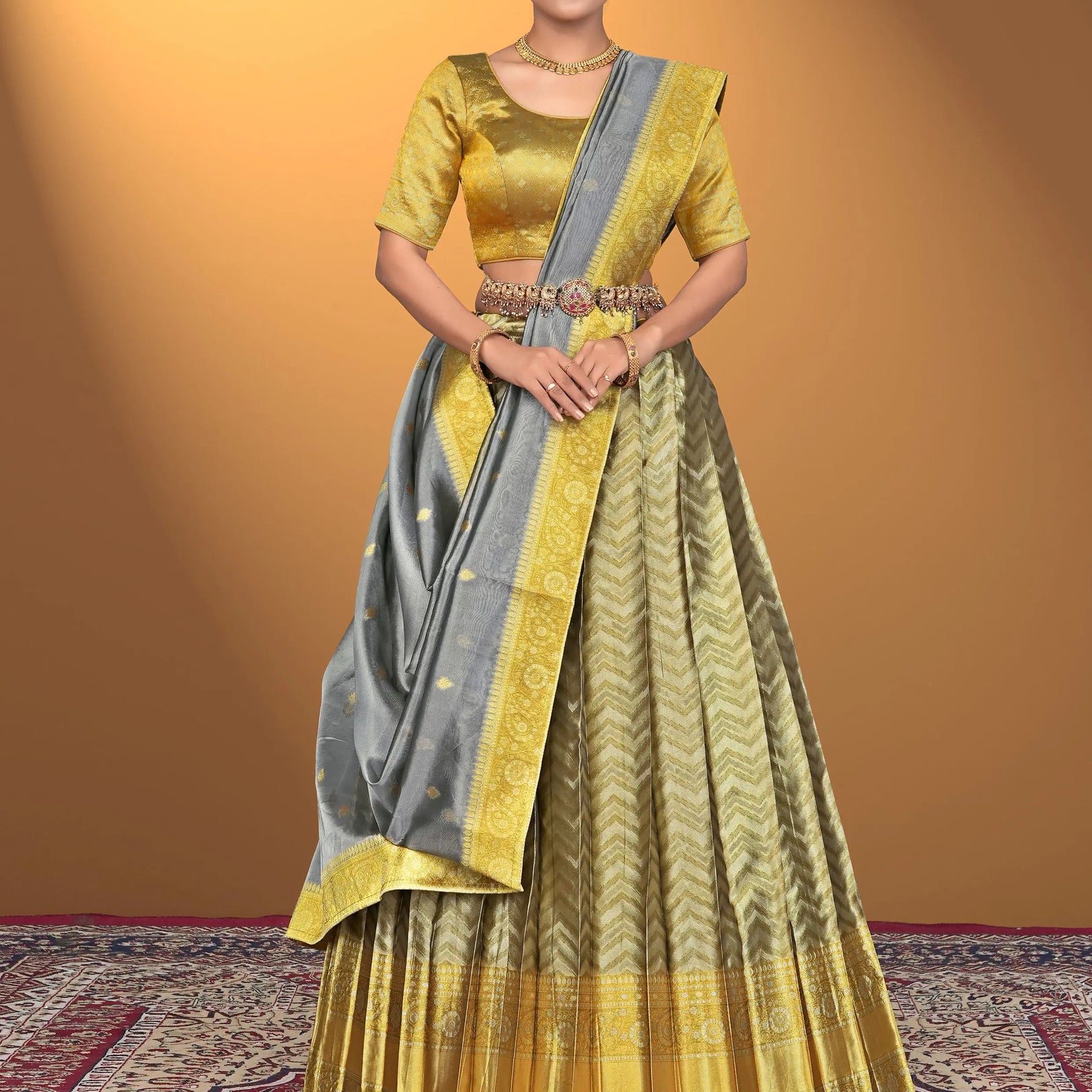 Woman wearing a yellow and gray traditional lehenga choli