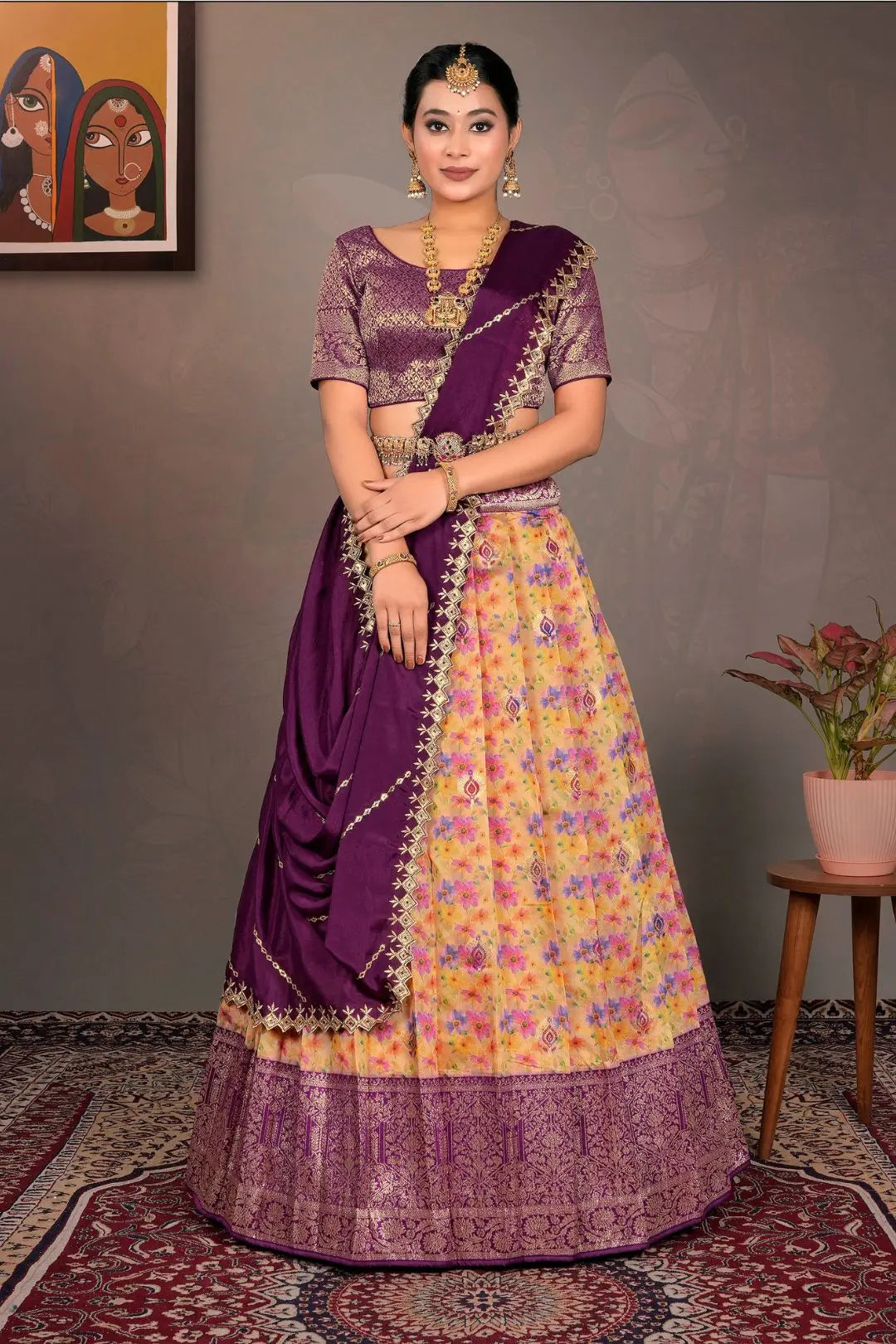 Woman wearing a traditional purple and yellow lehenga choli with a floral pattern