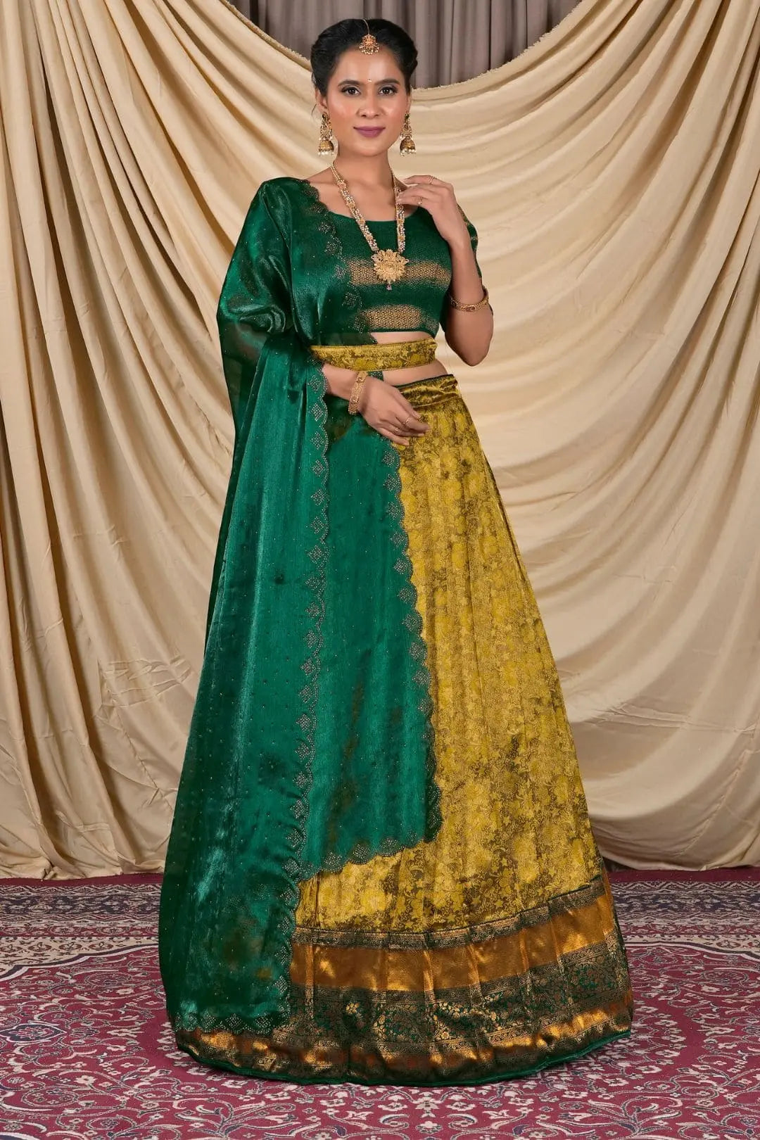 Woman wearing a green and yellow traditional lehenga choli with dupatta