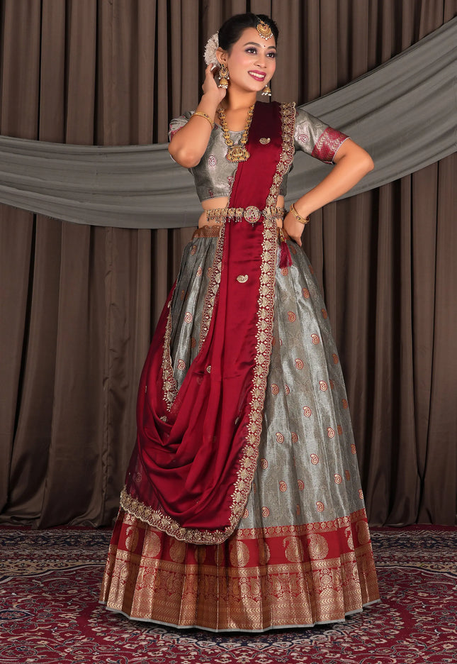 Woman in traditional red and gray lehenga choli