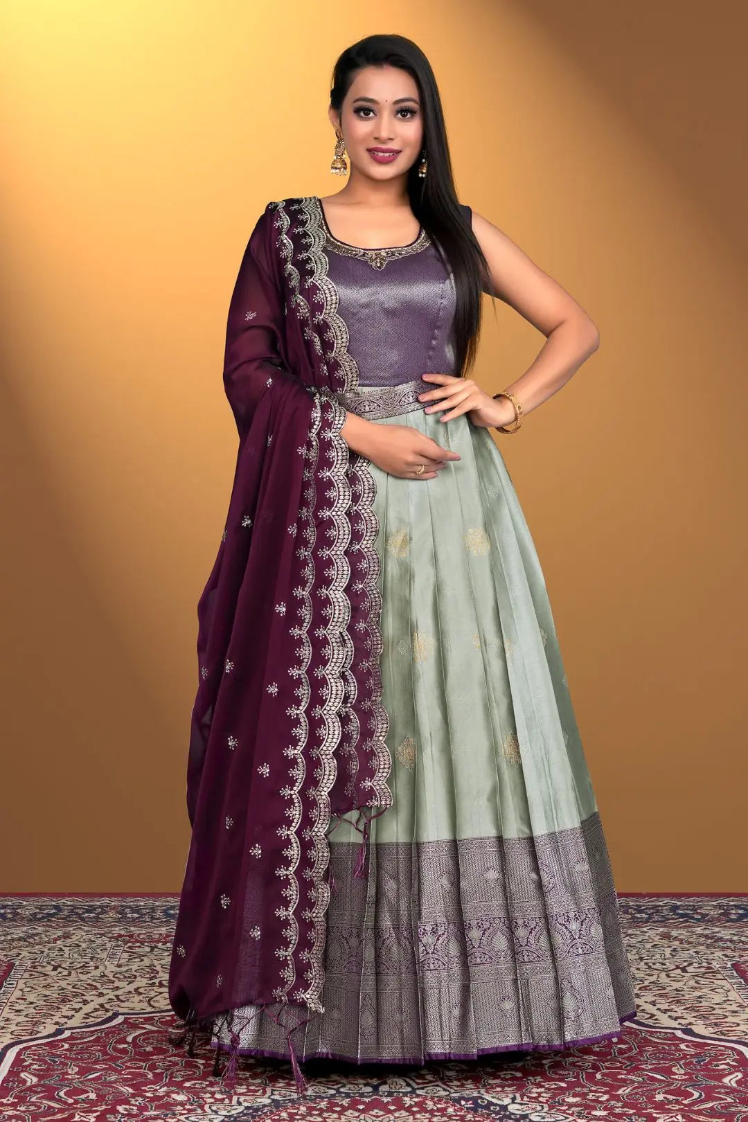 Woman wearing a traditional outfit with a purple and gray gown with dupatta