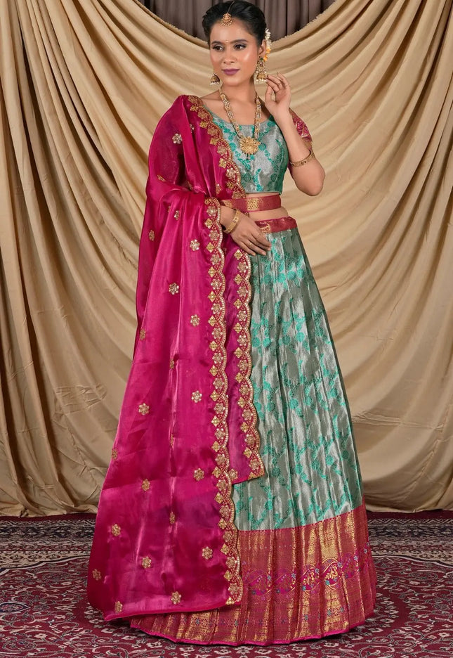 Woman wearing a traditional outfit with a pink dupatta and Gray lehenga