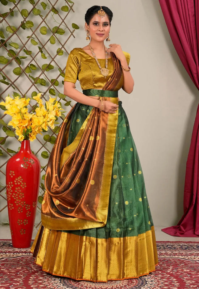 Woman wearing a green and gold traditional outfit