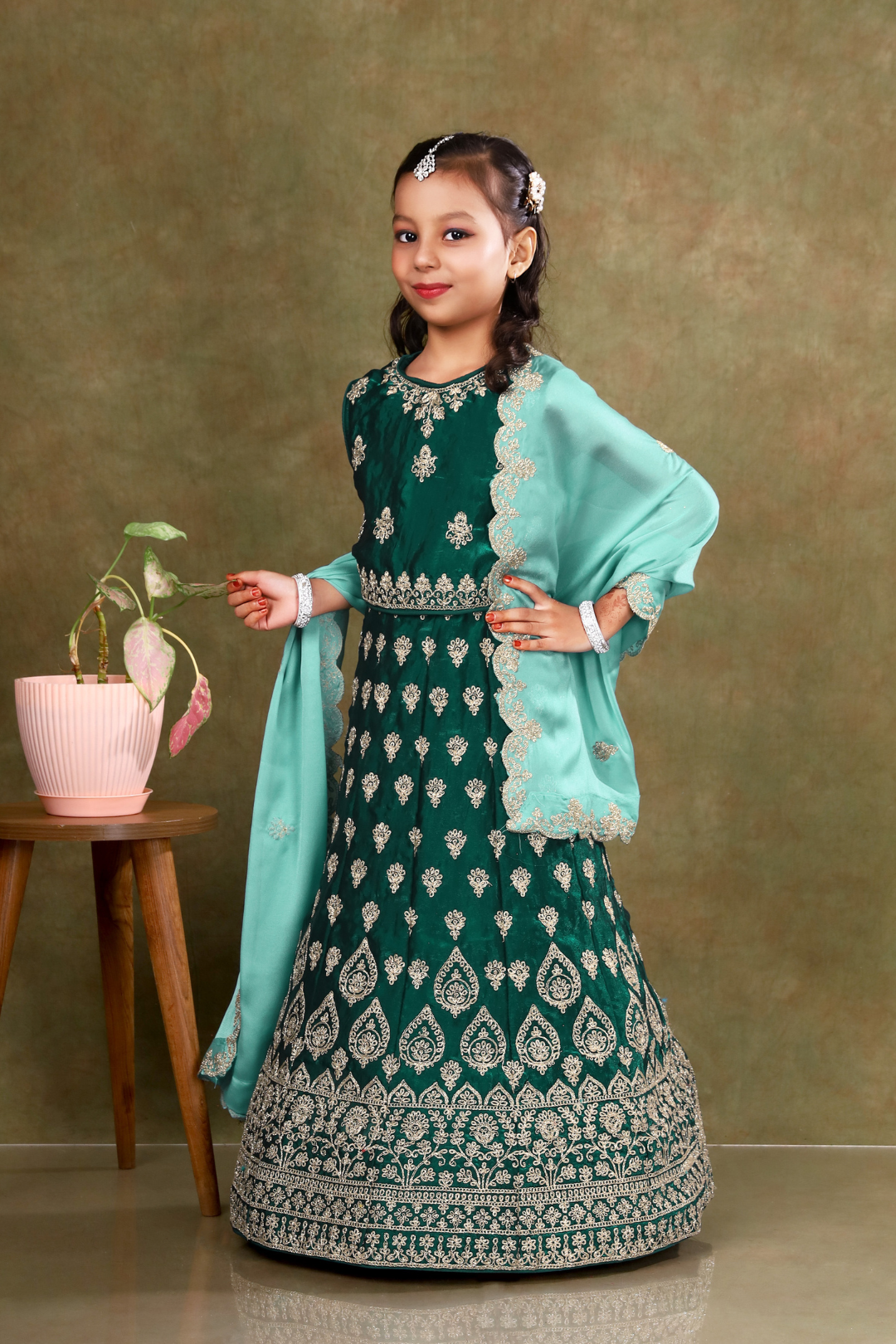 Young girl in a green-coloured kids' readymade lehenga
