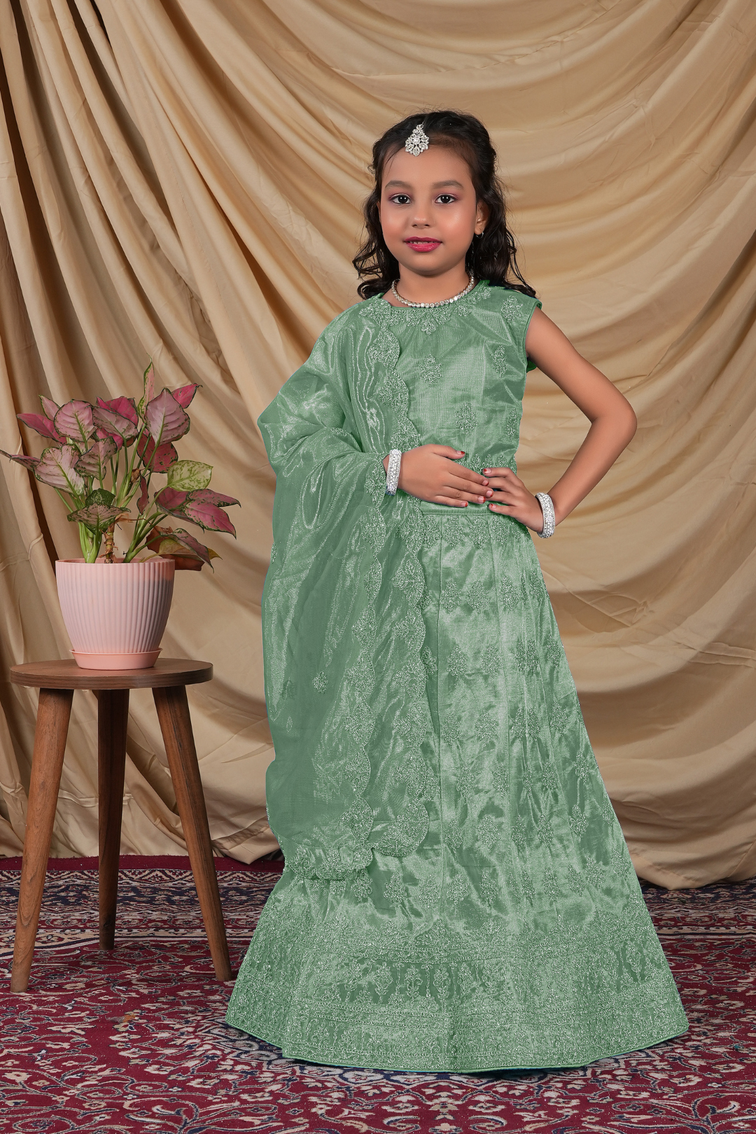 Young girl in a green-coloured kids' readymade lehenga choli