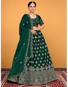 Woman wearing a green embroidered traditional lehenga choli