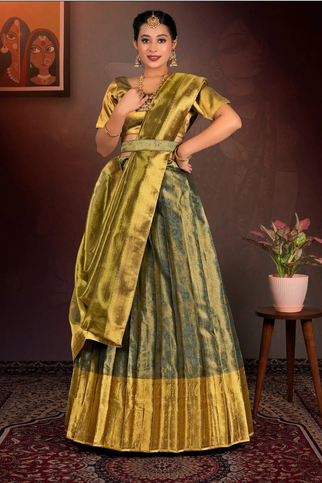 Woman in a traditional green and gold lehenga choli  with dupatta