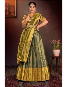 Woman in a traditional green and gold lehenga choli  with dupatta