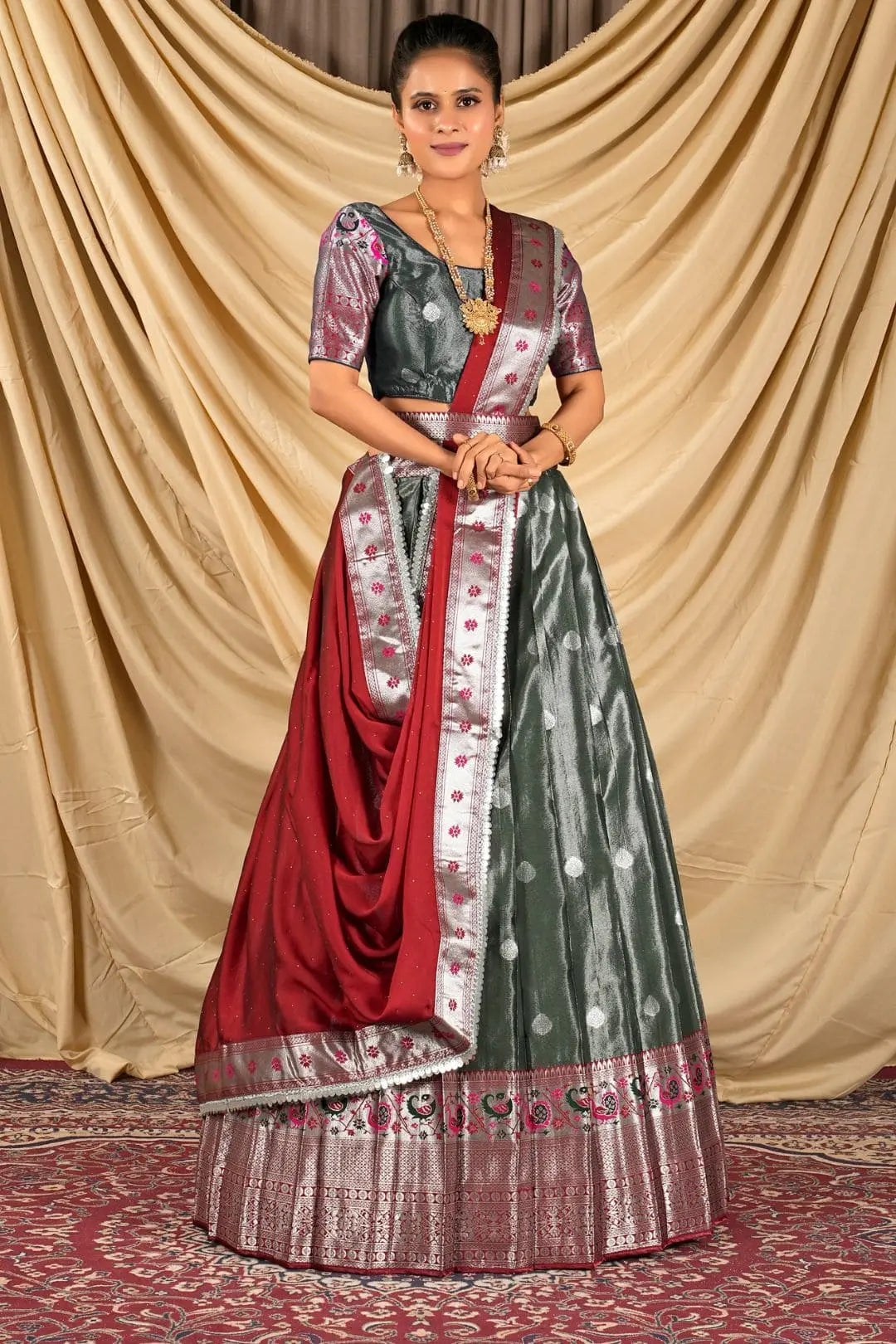 Woman wearing a traditional lehenga choli with a red and green pattern