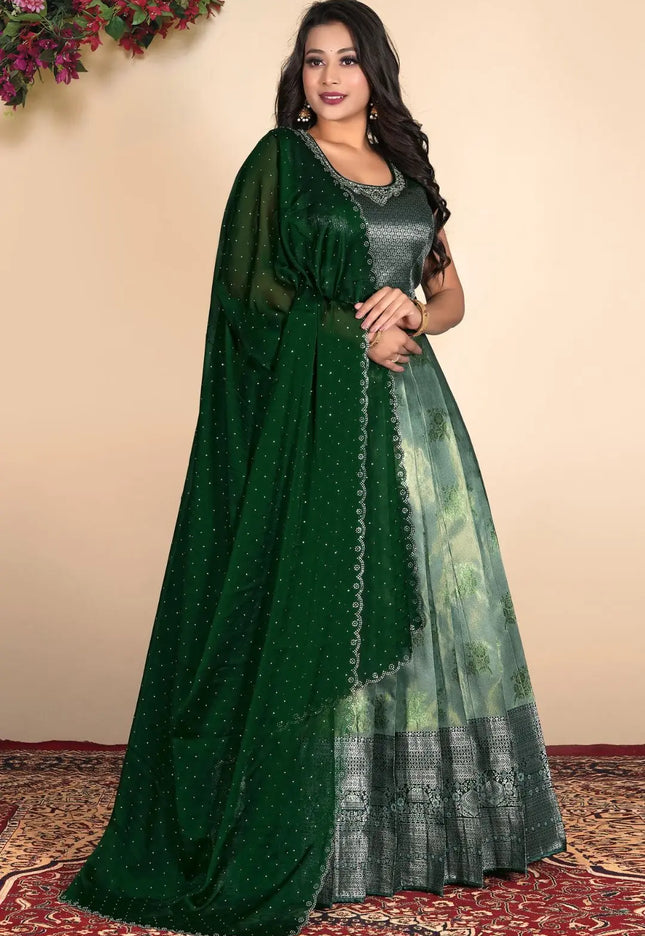 Woman wearing a green gown with a matching dupatta