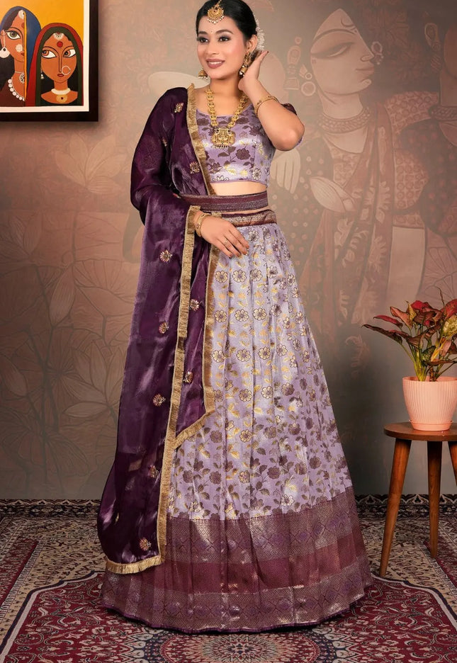 Woman in a traditional purple and lavender lehenga choli with dupatta