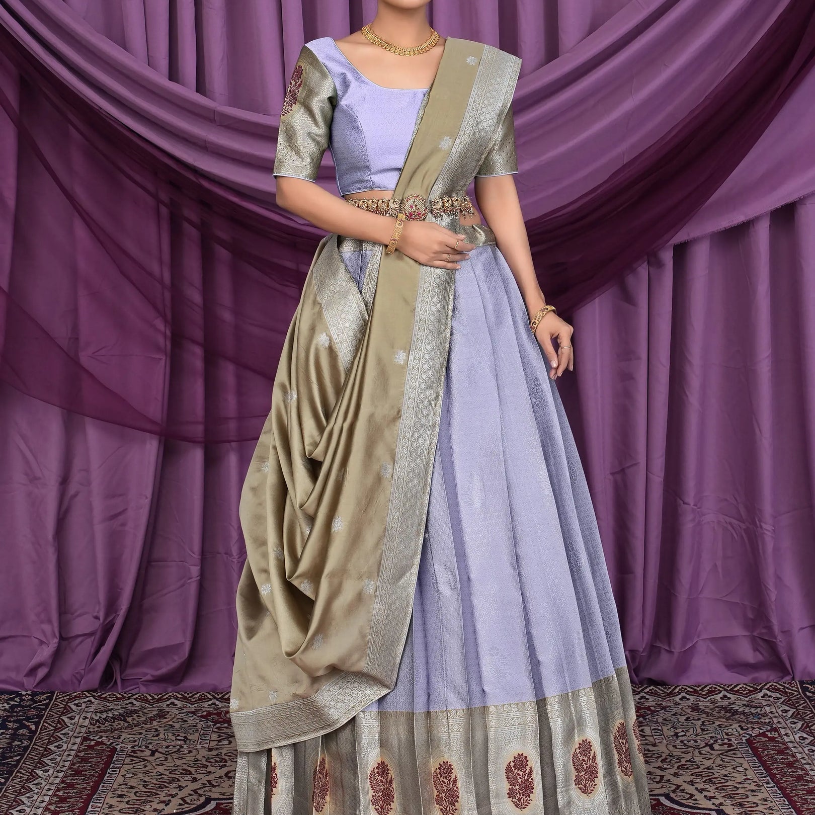 Woman in a traditional lavender color lehenga choli with chiku dupatta