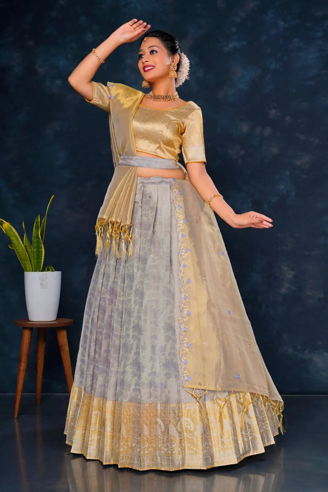 Woman in a traditional gold and lavender lehenga choli with dupatta