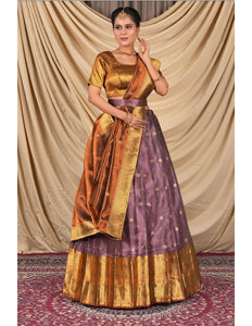 Woman wearing a traditional gold and purple lehenga choli with dupatta