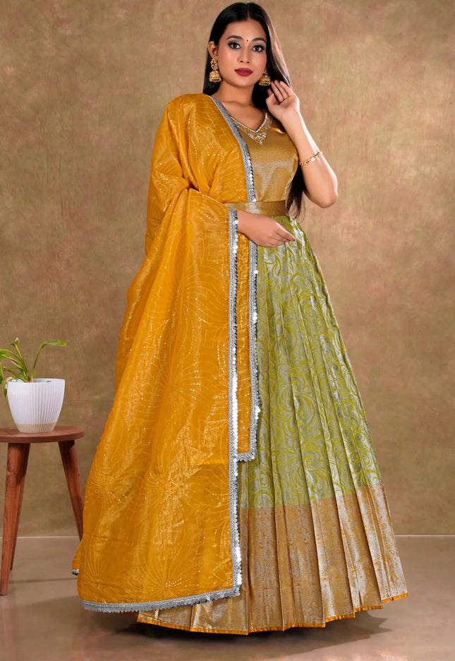 Woman wearing a mustard yellow and lemon long gown with dupatta