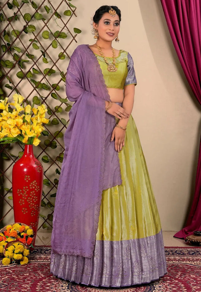 Woman wearing a green and purple lehenga choli with dupatta