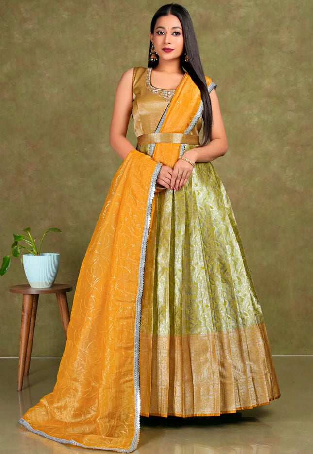 Woman wearing a traditional outfit with a yellow and green gown