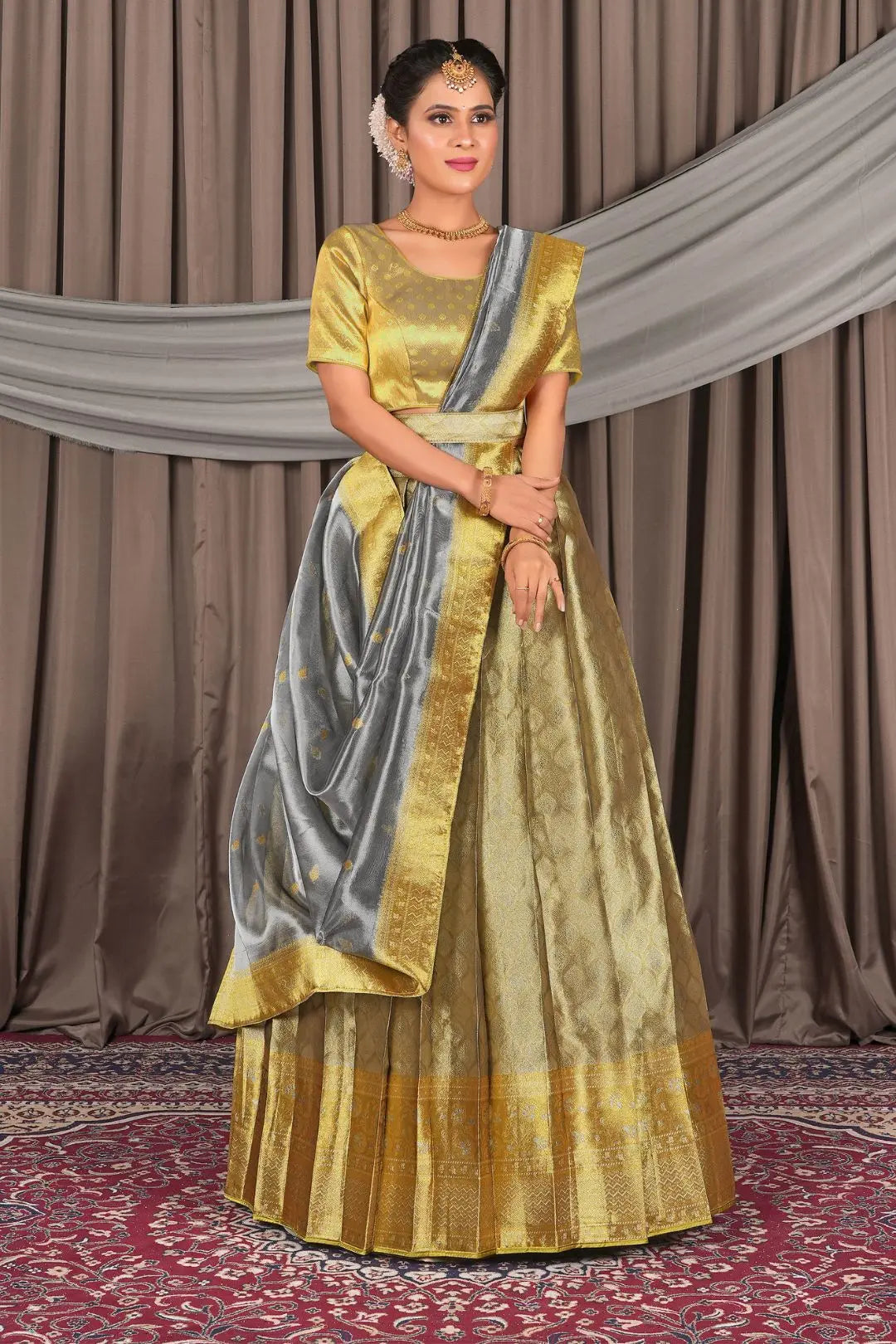 Woman wearing a traditional gold and silver lehenga choli with dupatta