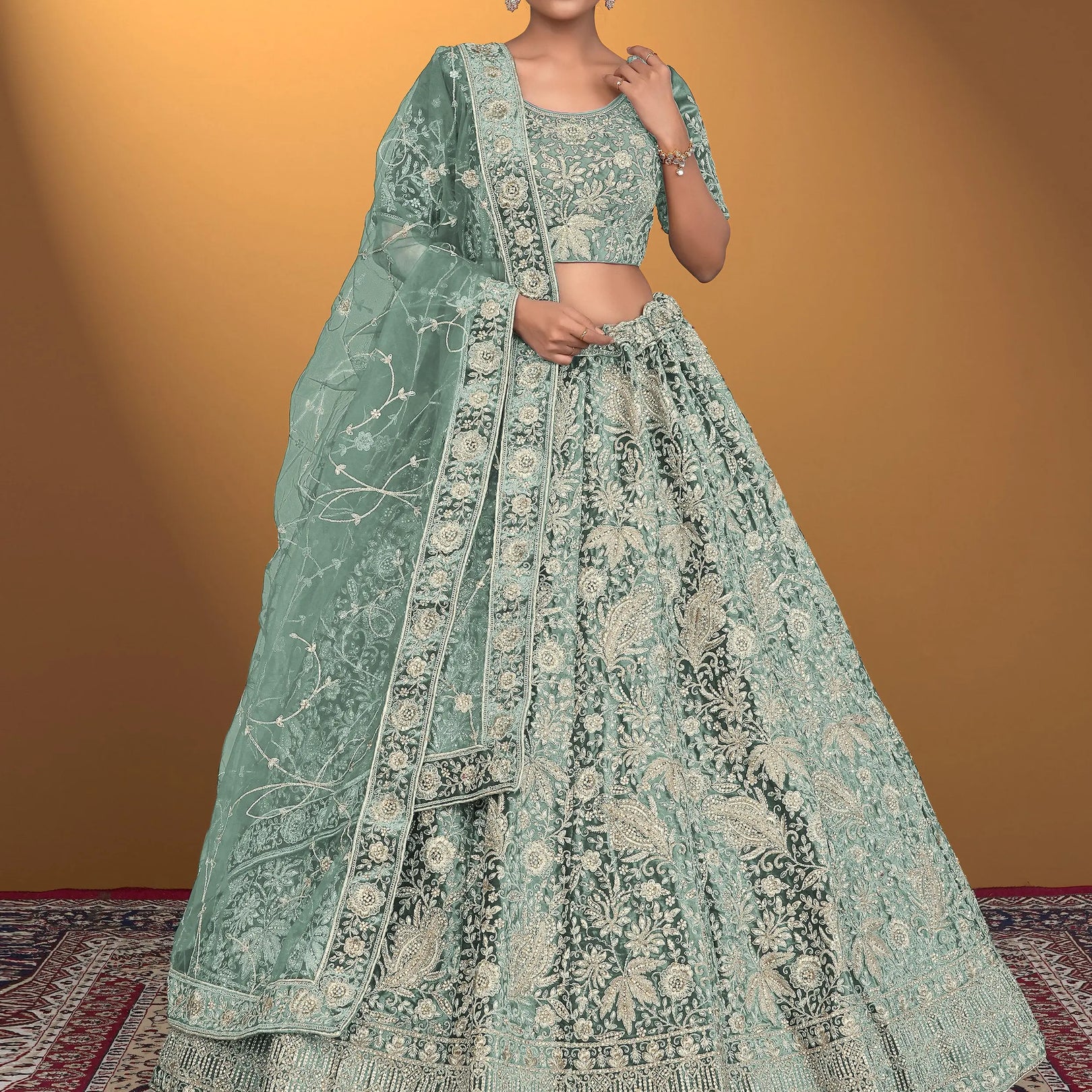Woman wearing a light green embroidered traditional outfit on a patterned