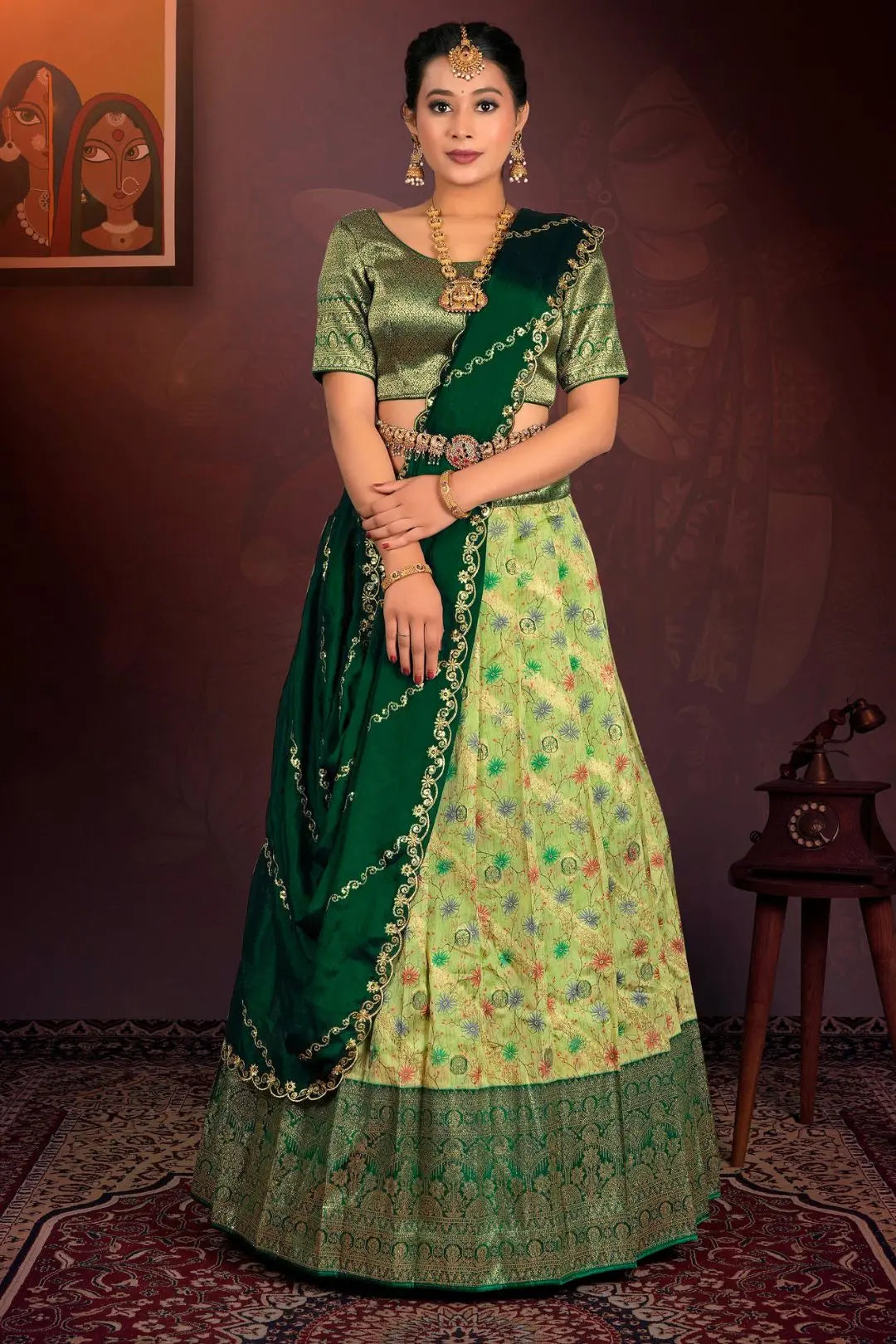 Woman in a green traditional outfit with a patterned lehenga choli