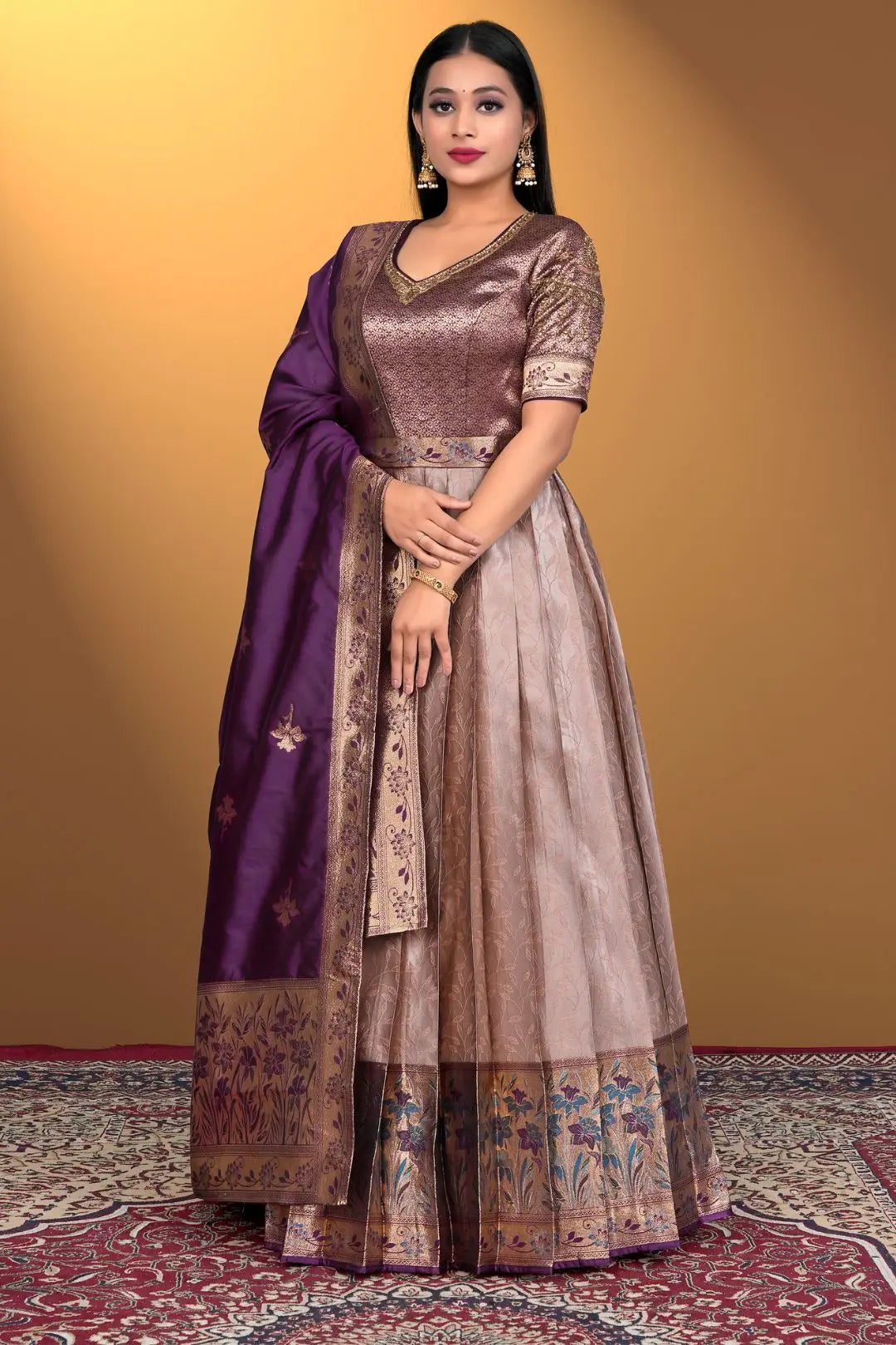 Woman wearing a traditional outfit with a purple dupatta