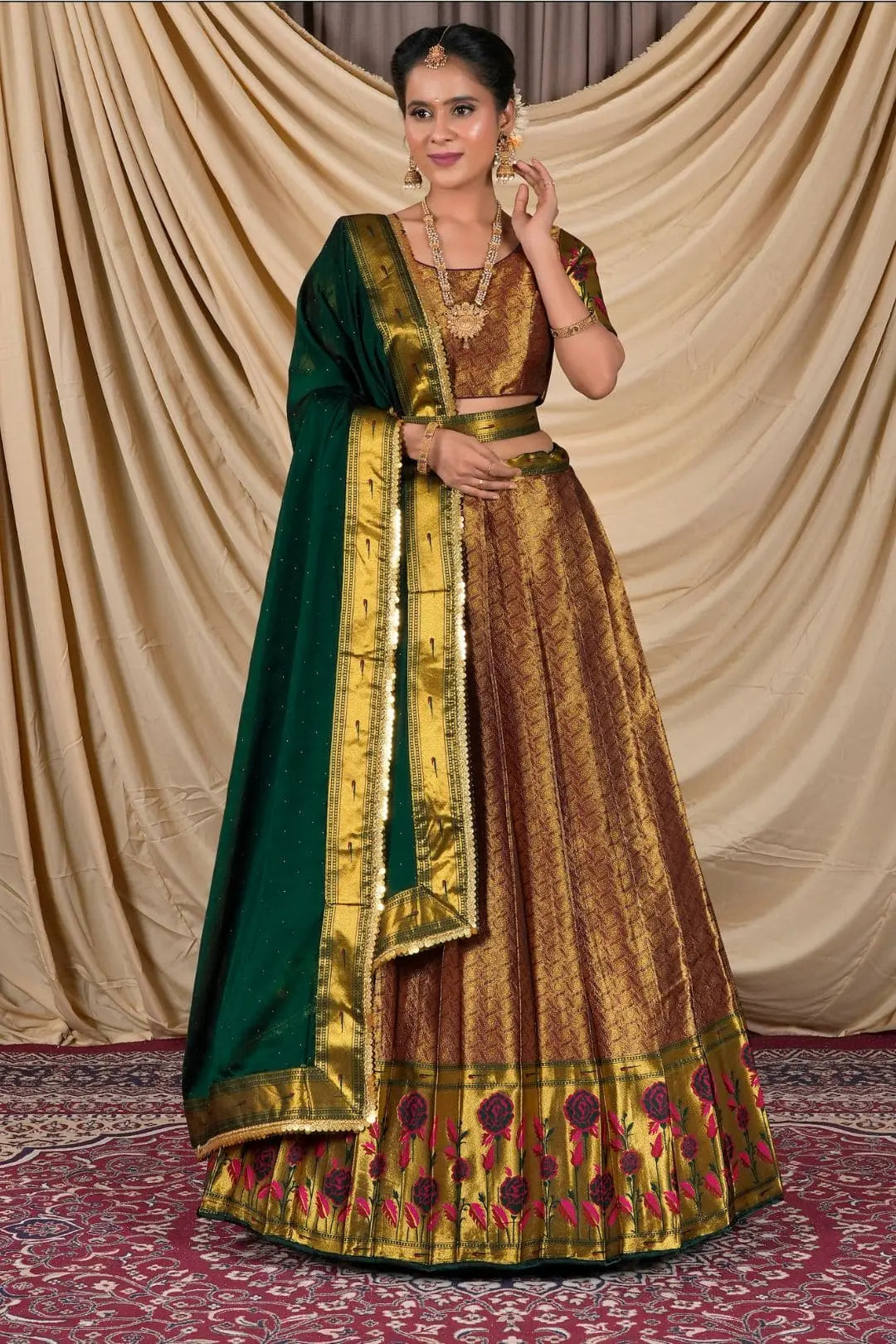 Woman wearing a traditional gold and green lehenga choli with dupatta