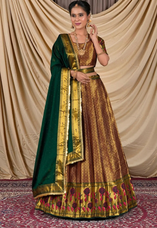 Woman wearing a traditional gold and green lehenga choli with dupatta