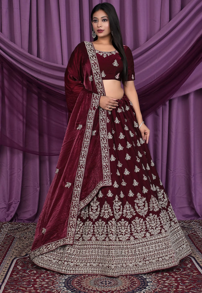 Woman wearing a maroon embroidered traditional lehenga choli