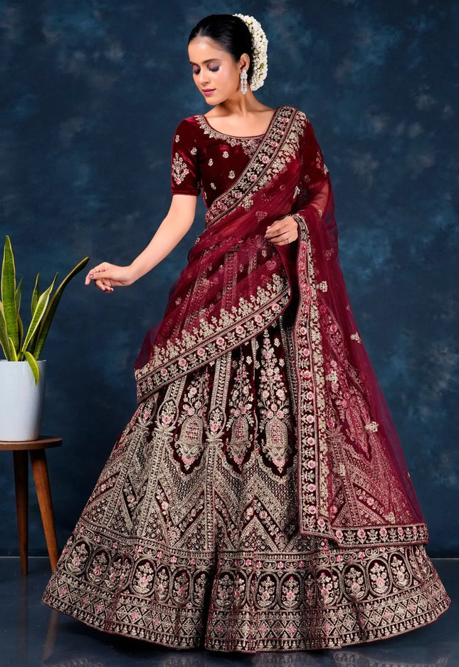 Woman in a maroon embroidered traditional lehenga choli with dupatta